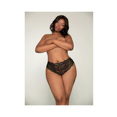 Plus size model wearing black lace tanga panty with open-crotch and elastic open back detail against neutral background.