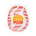 Tenga Egg Tube disposable male stroker in white with red stripes and orange label, compact and portable design.