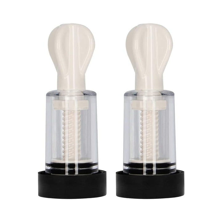 Pair of white and transparent electro nipple twisters with black bases, designed for adjustable suction and stimulation.