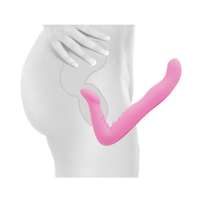 Pink ergonomic strapless strap-on dildo shown in use with body outline for placement demonstration.