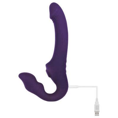 Purple silicone strapless strap-on with dual curved shafts and USB charging cable attached.