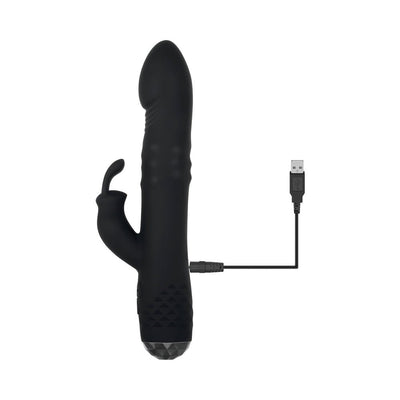 Black rotating rabbit vibrator with textured grip and USB charging cable on white background.