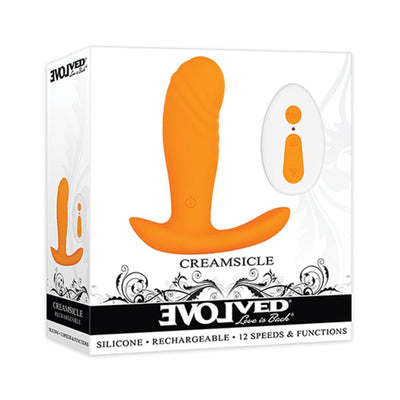 Orange silicone Creamsicle vibrator with ergonomic base and white remote control, displayed in branded packaging.