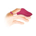 Hand wearing a magenta silicone finger vibrator with a textured, curved tip and adjustable ring band.