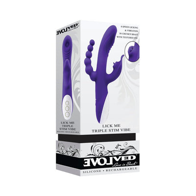Purple triple-stimulation vibrator with three distinct shafts and white control panel, shown on product packaging.