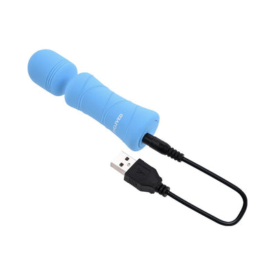 Blue compact vibrating mini wand with textured silicone surface and USB charging cable attached.