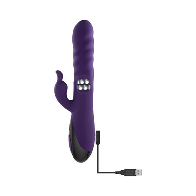 Purple silicone rabbit vibrator with rotating beads and USB charging cable on white background