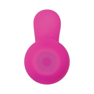 Top view of a pink silicone vibrator with a rounded base and a curved extension.