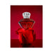 Red diamond-shaped perfume bottle with clear cap resting on a red rose petal against a red background.