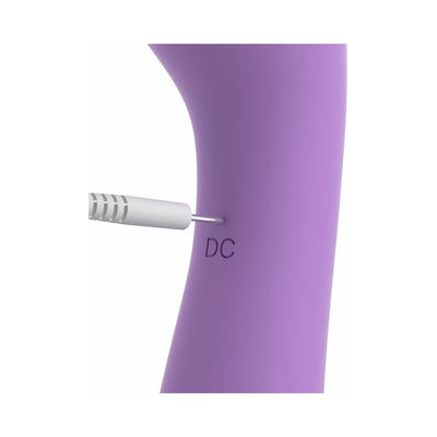Close-up of purple Duo Wand Massage-Her showing the charging port with a white plug inserted.