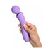 Hand holding a lavender ergonomic Duo Wand Massage-Her with control buttons visible on the handle.