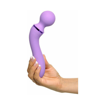 Hand holding a lavender ergonomic Duo Wand Massage-Her with a rounded head and curved handle against a white background.