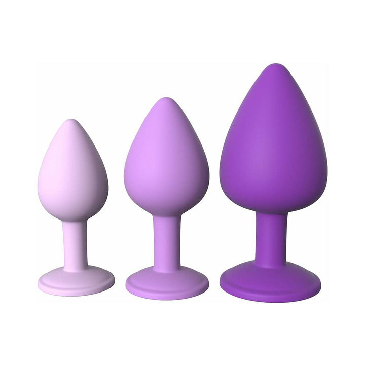 Set of three silicone anal trainers in graduated sizes with tapered tips, in shades of purple, designed for comfortable beginner use.