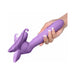 Hand holding a purple vibrating roto suction device with flexible silicone cup shown in motion.