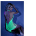 Woman seated on a stool wearing a neon green glow net halter dress with an open back under blue lighting.