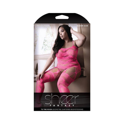 Plus size model wearing neon pink sheer geometric gartered bodystocking seated by a window in soft natural light.