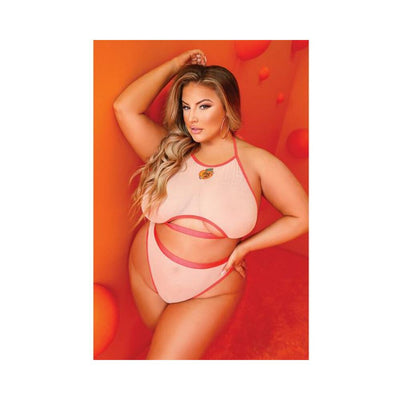 Curvy model wearing peach cut-out halter top and cheeky panty set against vibrant orange background.