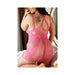 Curvy woman kneeling on bed wearing pink lace multi-way strap dress with floral back tattoos visible