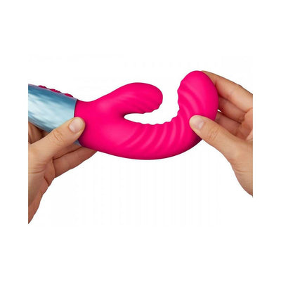 Hands holding a flexible pink dual-density liquid silicone rabbit vibrator with textured curves and a silver handle.