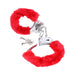 Red furry-lined metal handcuffs with keys and quick-release mechanism on white background