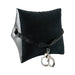 Inflatable wedge pillow with black velvety surface, adjustable nylon strap, and attached metal handcuffs.