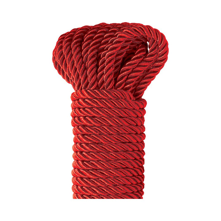 Coiled deluxe silky red rope with a smooth, twisted texture for Japanese-style bondage and Shibari play.