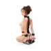 Woman kneeling wearing Fetish Fantasy Series Fantasy Harness with adjustable straps and wrist cuffs in a bondage pose