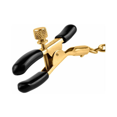 Close-up of gold-tone adjustable nipple clamp with black rubber tips and connecting chain.
