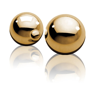 Pair of polished gold-tone metal Ben Wa balls with reflective surfaces on a white background.