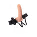 Flesh-toned hollow strap-on with adjustable black harness and attached remote control for vibration settings.