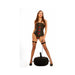 Woman in black corset and fishnet stockings standing behind a black inflatable seat with attached vibrating accessory and remote control.