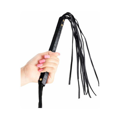 Hand holding a black leather cat o nine tails whip with multiple thin leather tails against a white background.