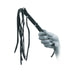 Hand holding a black leather flogger whip with multiple tails and studded handle.