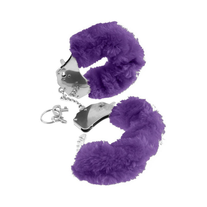 Pair of metal handcuffs lined with soft purple faux fur and accompanied by two small keys on a white background.
