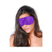 Woman wearing a smooth satin purple eye mask with long dark hair against a white background.