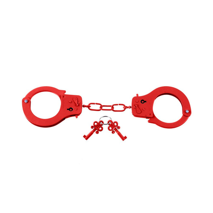 Red metal handcuffs with matching keys on a white background.
