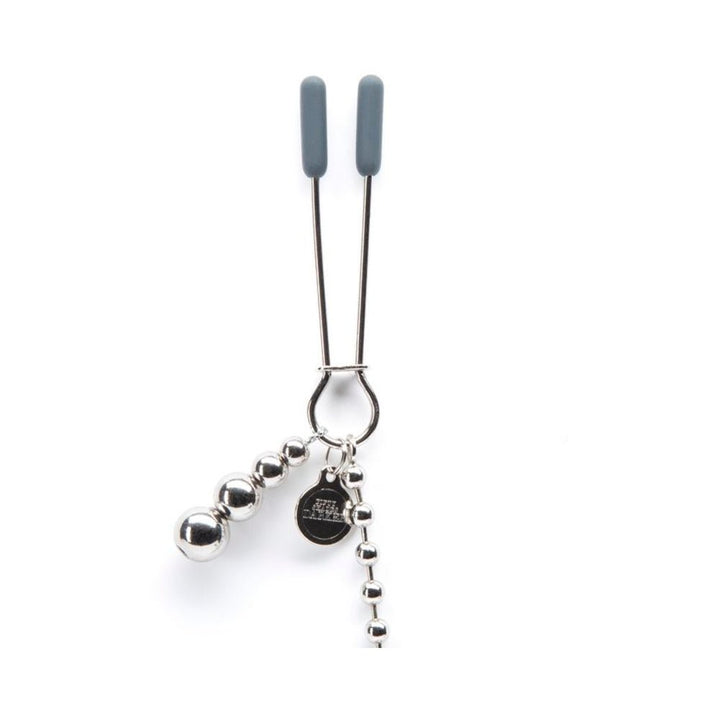 Fifty Shades Darker adjustable nipple clamps with silicone tips and attached silver beaded chain on white background.