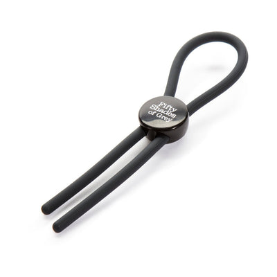 Black adjustable silicone love ring with Fifty Shades of Grey logo on a white background.
