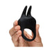 Hand holding a black silicone rabbit ear vibrating love ring with a smooth finish and flexible ears.