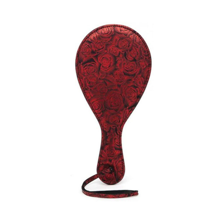 Red round paddle with embossed rose pattern and wrist strap from Fifty Shades of Grey Sweet Anticipation collection.