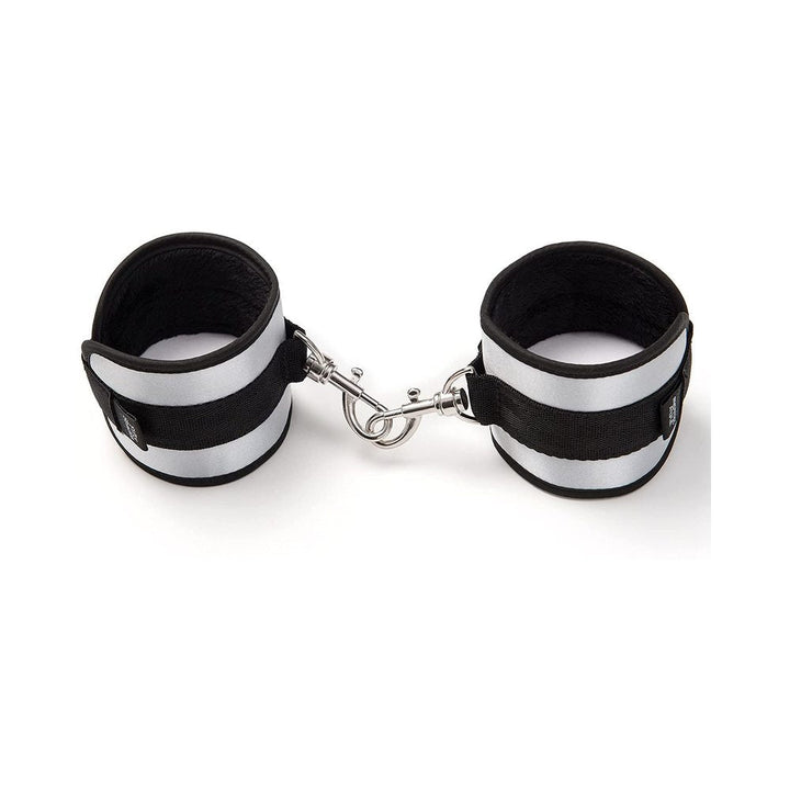 Pair of black and silver velvet-lined bondage handcuffs with metal clips for secure restraint play.