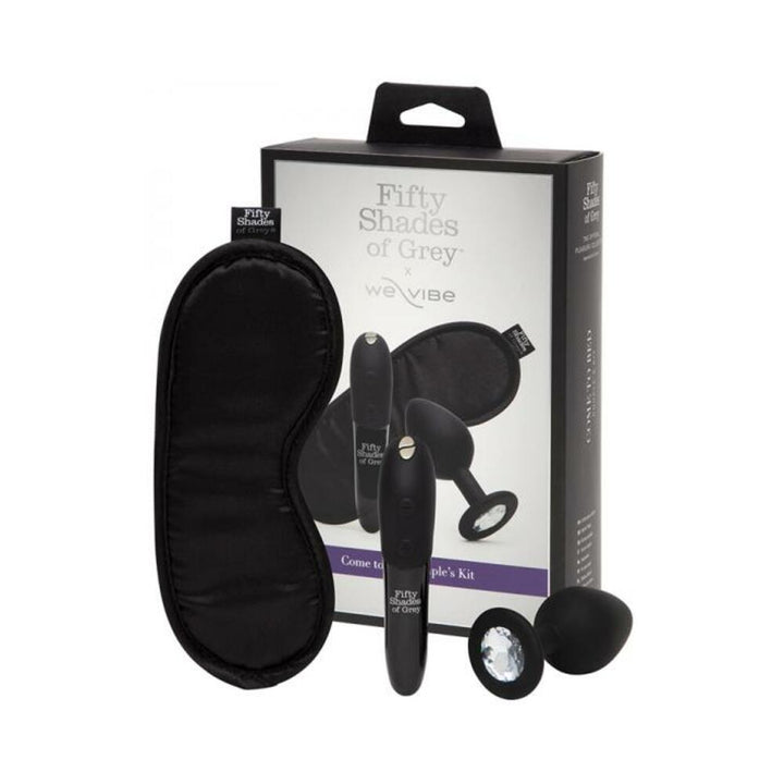 Fifty Shades of Grey We-Vibe Come to Bed Kit with black satin blindfold, sleek vibrator, and silicone butt plug with crystal base.
