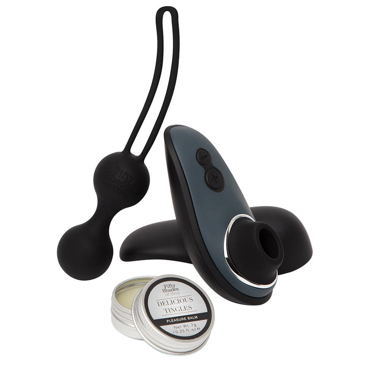 Fifty Shades of Grey Womanizer Desire Blooms Kit in black with clitoral stimulator, Kegel exerciser, and pleasure balm.