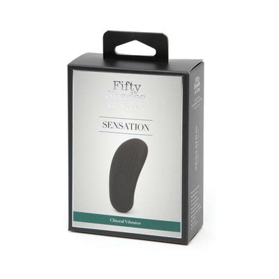 Fifty Shades of Grey Sensation clitoral vibrator in sleek black pebble shape shown in branded retail packaging.