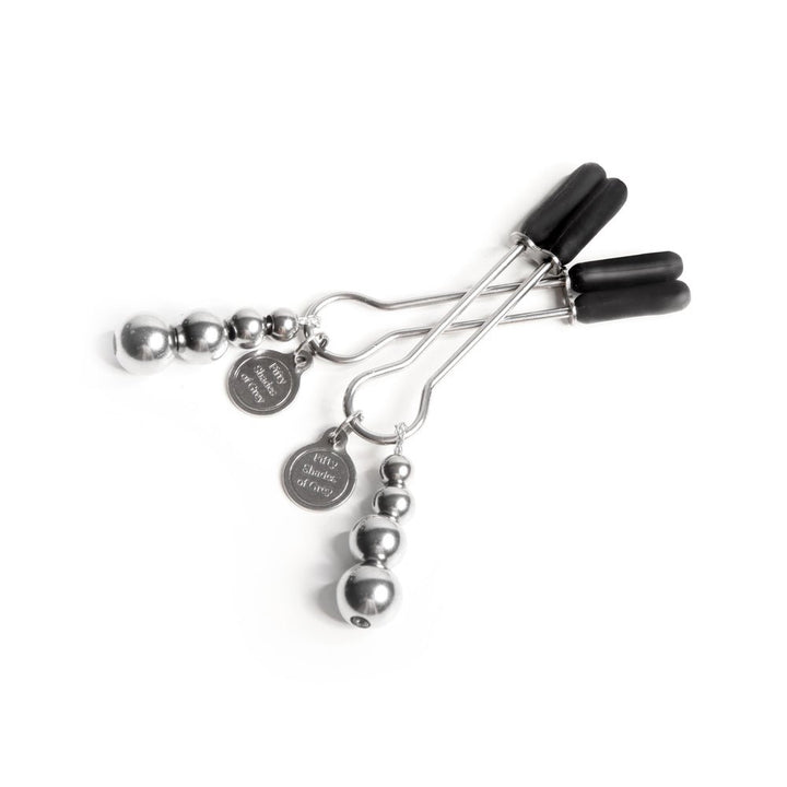 Fifty Shades The Pinch Nipple Clamps with adjustable screws and black rubber tips, featuring branded metal tags.