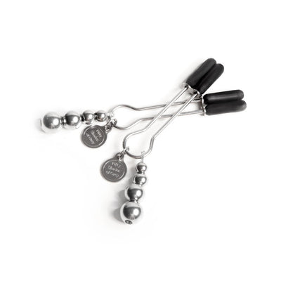 Fifty Shades The Pinch Nipple Clamps with adjustable screws and black rubber tips, featuring branded metal tags.