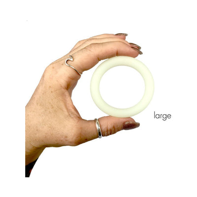 Hand holding a large clear glow-in-the-dark silicone ring against a white background with "large" label.