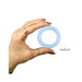 Hand holding a medium-sized clear blue silicone Firefly Halo ring against a white background.