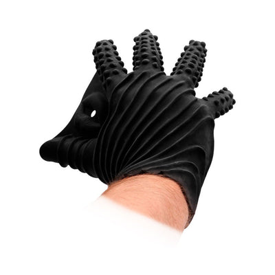 Black textured sensory glove with raised dots on fingers and ribbed design on back, worn on a hand.