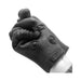Black silicone stimulation glove with textured fingers and palm, designed for enhanced sensory pleasure.
